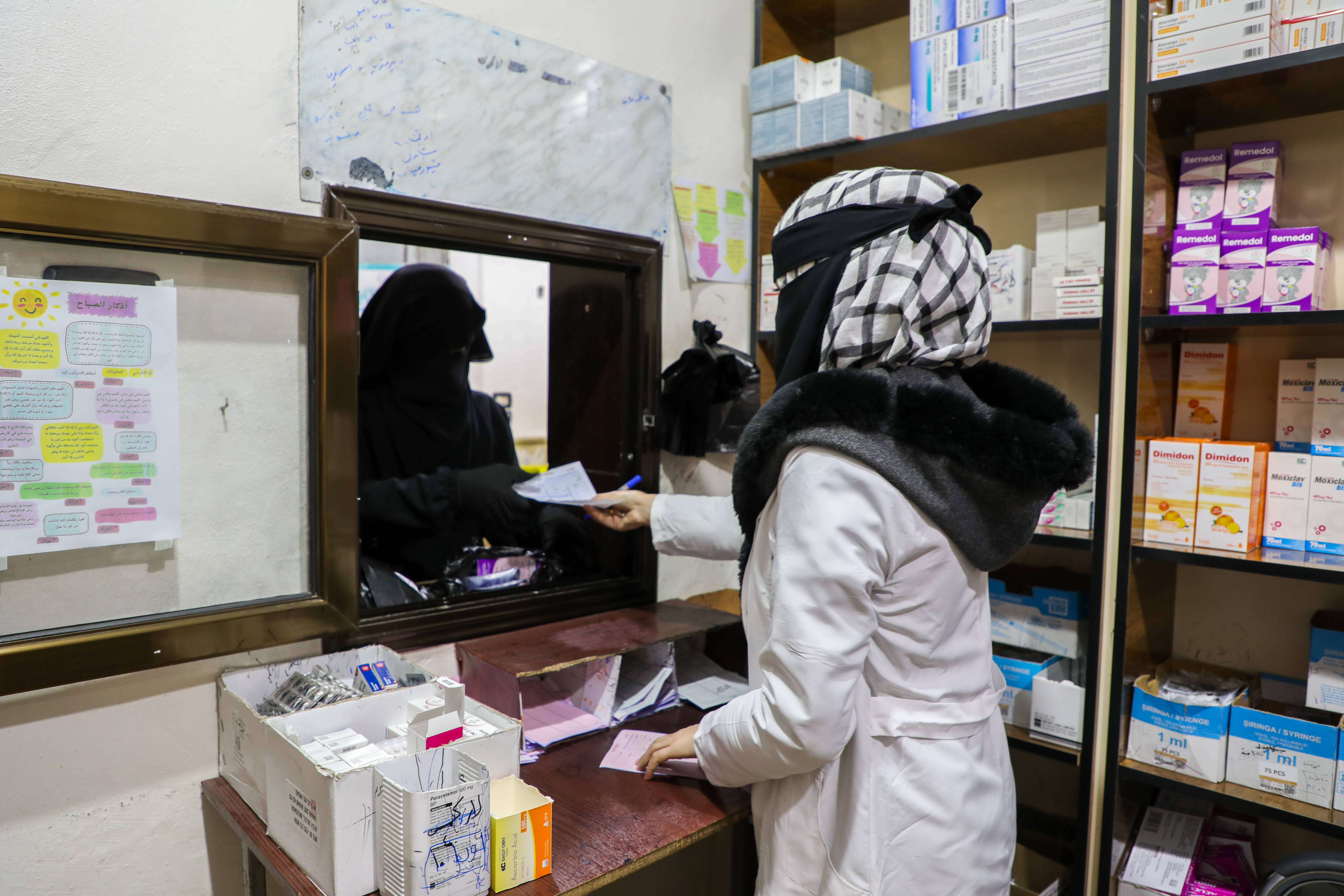Health workers and patients at the Darat Izza Primary Healthcare Centre