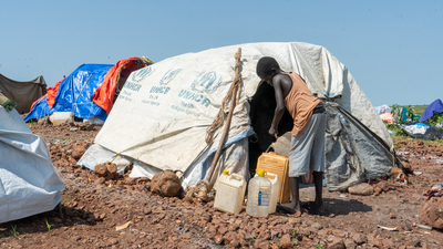 Sudanese refugee collecting water
