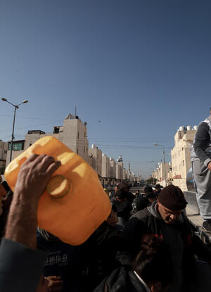 Youssef Al-Khishawi, an MSF water and sanitation agent, oversees a water distribution for displace
