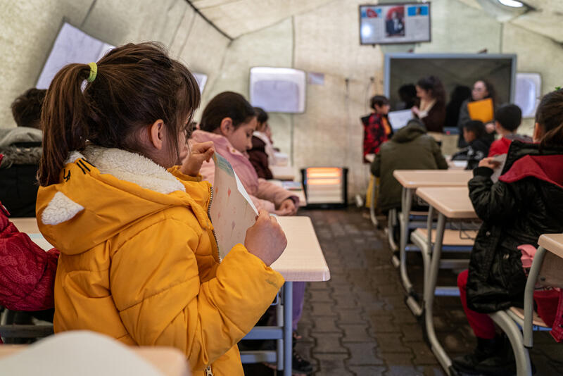 Children show their drawings during an MSF supported psychosocial support activity in Arguvan, on the outskirts of Malatya.