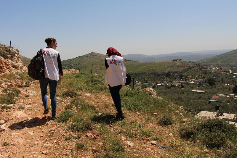 An MSF psychologist and translator walk in Burin village to meet a patient. Some villagers live in remote areas and are afraid to leave their house to go to MSF clinics because of settlers attacks. Palestine, 4 April 2018.