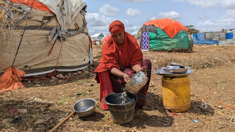 Muna Ibrahim, 39, a mother of five, washes dishes at her compound in Nimole IDP camp, Baidoa, Somalia. Nimole is one of the camps where MSF provides water and sanitation support as part of its drought response.