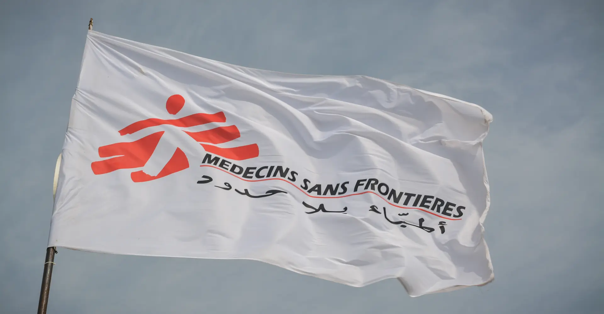 The MSF flag flutters in the wind at MSF’s clinic in Al-Tanideba camp for Tigray refugees, in Eastern Sudan.