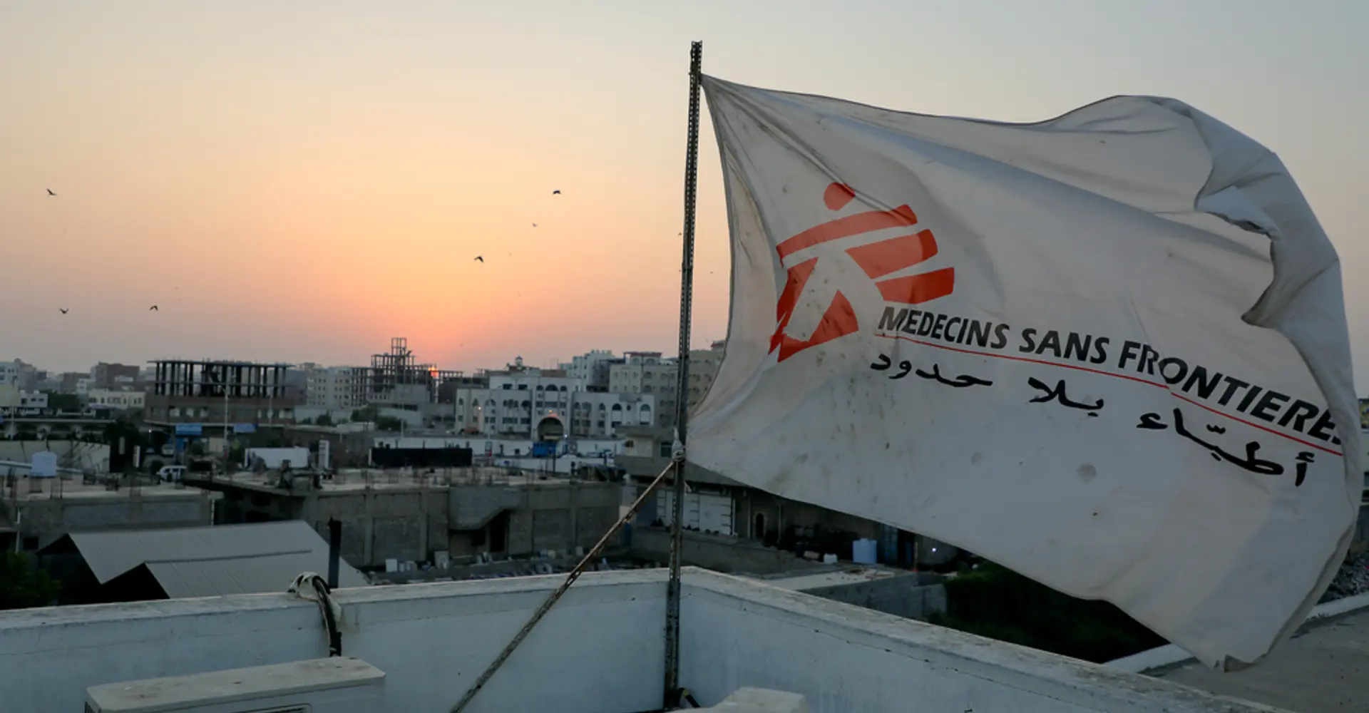 MSF flag over the top of the hospital