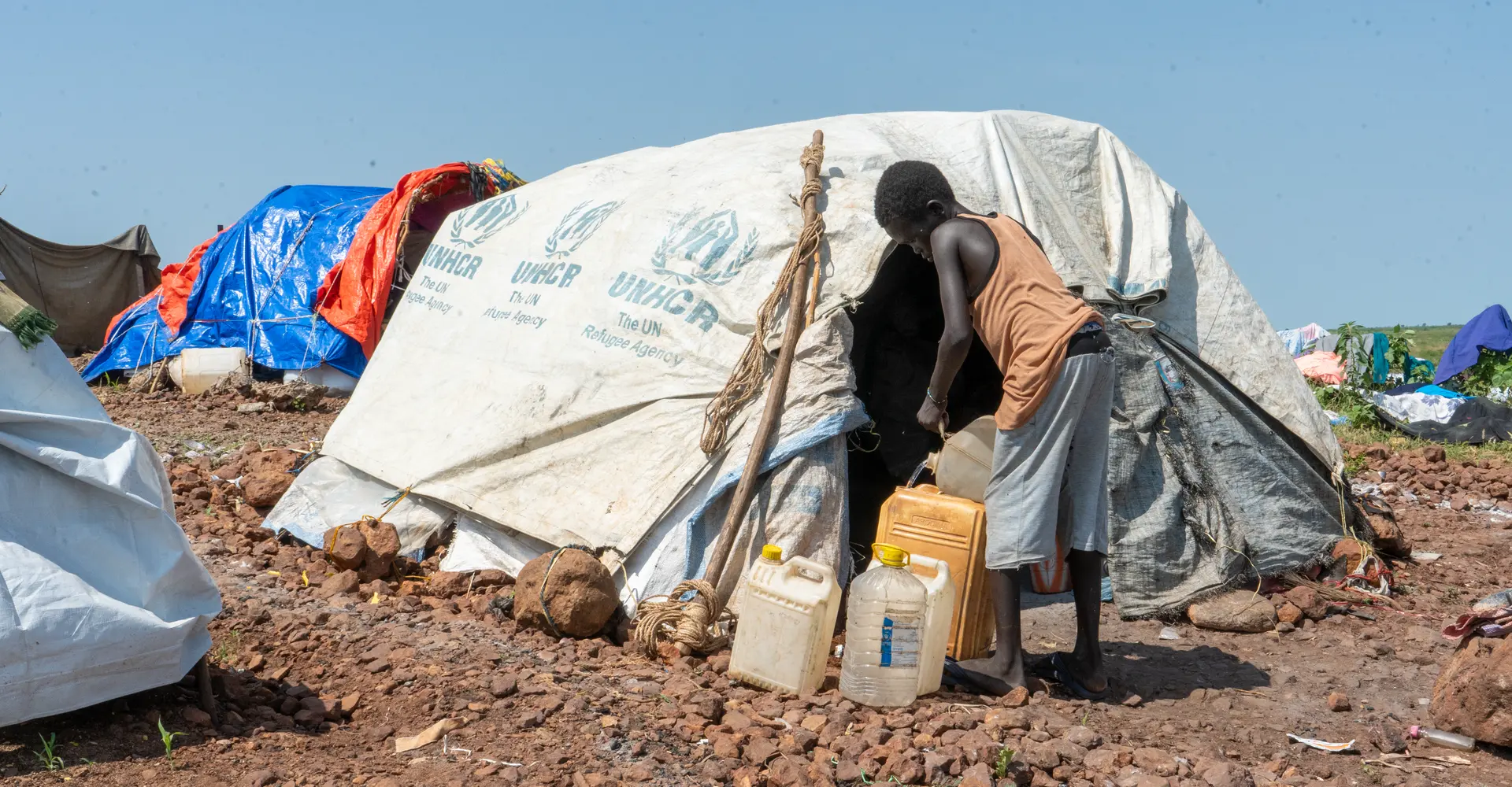 Sudanese refugee collecting water